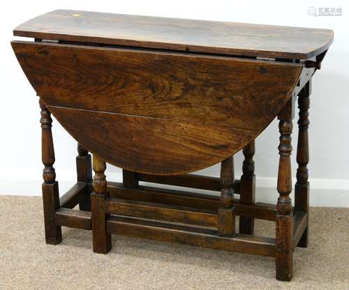 AN OAK GATELEG TABLE, MID 18TH C, THE DROP LEAF TOP FITTED WITH A DRAWER, ON SLENDER BALUSTER LEGS