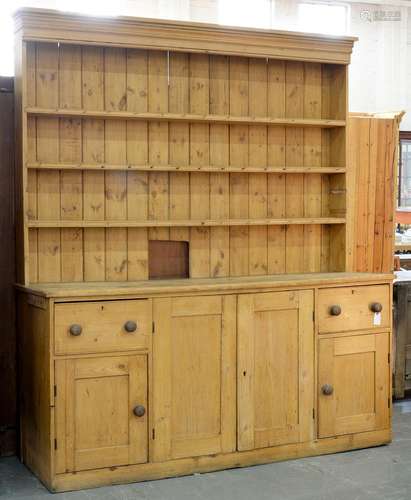 A VICTORIAN WAXED PINE DRESSER WITH BOARDED RACK, THE LOWER PART ENCLOSED BY PANELLED DOORS, 238CM