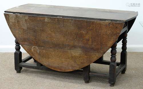 AN OAK GATELEG TABLE FITTED WITH A DRAWER TO ONE END, ON BOBBIN TURNED LEGS UNITED BY STRETCHERS,