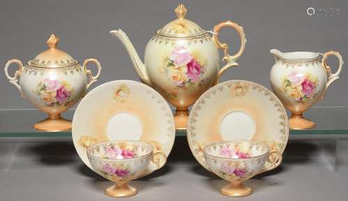 A CONTINENTAL PORCELAIN VASE SHAPED TEA SERVICE, C1900, PRINTED AND PAINTED WITH FULL BLOWN