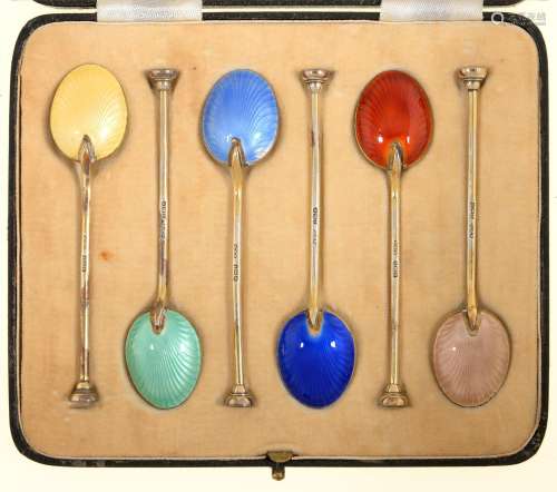 A SET OF SIX EDWARD VIII SILVER GILT AND HARLEQUIN GUILLOCHE ENAMEL COFFEE SPOONS, SEAL TERMINAL, BY