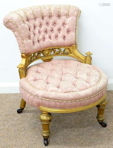 A VICTORIAN GILTWOOD NURSING CHAIR, C1870, THE FLARED BACK AND ROUND SEAT RECOVERED IN BUTTONED PINK