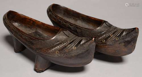 A PAIR OF SPANISH CARVED AND STAINED WOOD CLOGS, 19TH/EARLY 20TH C, 31CM L Good condition