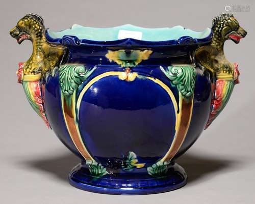 A MAJOLICA JARDINIERE, C1890, WITH GROTESQUE HANDLES AND STRAPWORK RELIEFS, THE INTERIOR