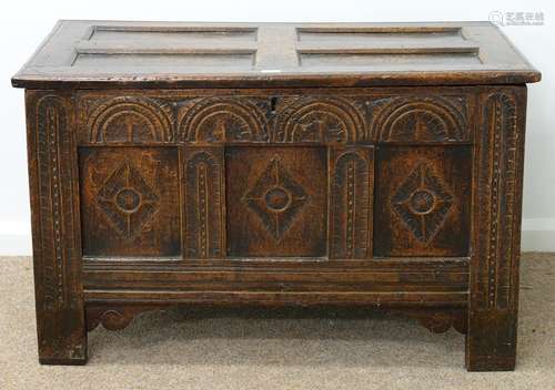 A CHARLES II JOINED OAK CHEST, LATE 17TH C, THE THREE PANEL FRONT CARVED AT LATER DATE WITH LUNETTES