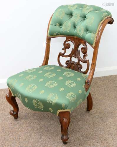 A VICTORIAN CARVED ROSEWOOD NURSING CHAIR, C1870, WITH SCROLLING OPENWORK BACK, ON MOULDED