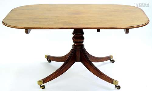 A VICTORIAN MAHOGANY BREAKFAST TABLE, ON BALUSTER PILLAR AND QUADRUPLE REEDED LEGS WITH BRASS