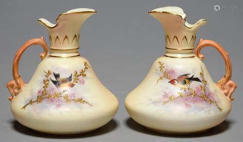 TWO LOCKE & CO WORCESTER PAIR SHAPED EWERS, C1902-14, PAINTED WITH A BIRD ON A RAISED GILT BRANCH,