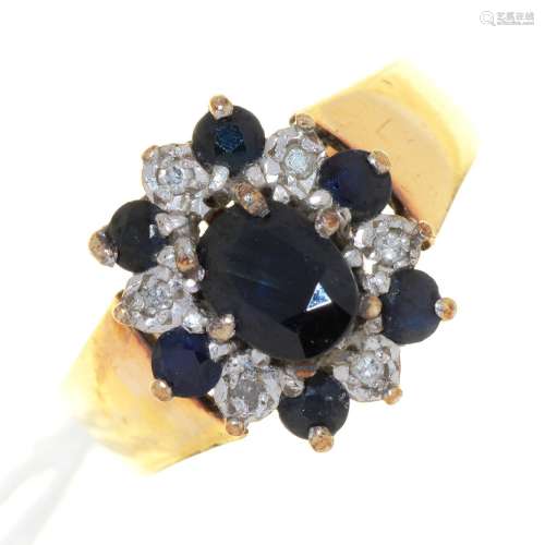 A SAPPHIRE AND DIAMOND CLUSTER RING, ILLUSION SET, ON 9CT GOLD BAND, BIRMINGHAM 1978, 4.7G, SIZE N