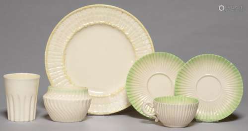 A BELLEEK SCROLL TEACUP, TWO SAUCERS AND A SUGAR BOWL, 1891-1926, WITH SHADED GREEN BORDER, SUGAR