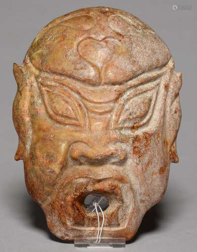 A SOUTH EAST ASIAN CARVED STONE MASK, 19.5CM H Minor abrasions and slight chips