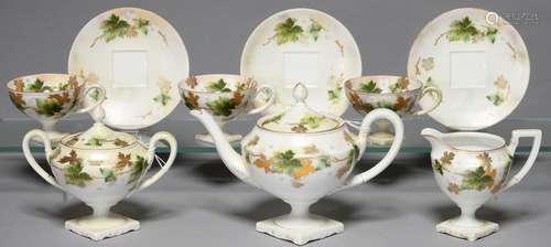 A CONTINENTAL PORCELAIN VASE SHAPED TEA SERVICE, C1900, PRINTED, PAINTED AND GILT WITH TRAILING