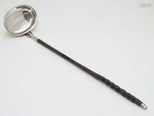 A 19thC white metal toddy ladle with twist handle. Approx 14