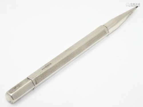 An Art Deco silver propelling pencil with engine turned decoration. Hallmarked London 1947 maker