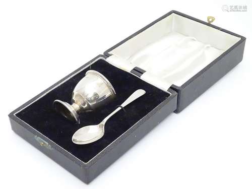 A silver egg cup and spoon hallmarked Birmingham 1974/75 maker B & Co. Cased. Please Note - we do