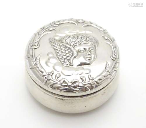 A small silver pot of circular form with embossed angel decoration hallmarked Birmingham 1902