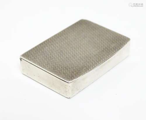 A small silver box with engine turned decoration to lid and gilded interior. Hallmarked London