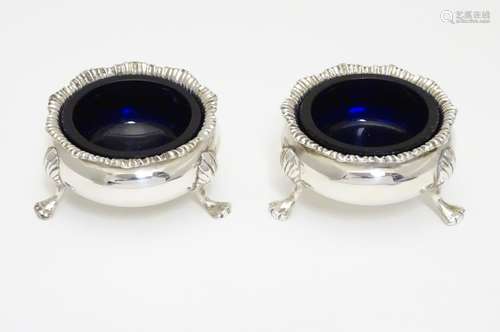 A pair of Victorian silver table salts with blue glass liners. Hallmarked London 1892 maker