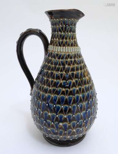 A Doulton Lambeth stoneware jug / ewer with relief decoration. Impressed marks under, maker HW