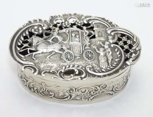 A silver pot pourri box with coaching scene to the pierced and embossed lid. Hallmarked London