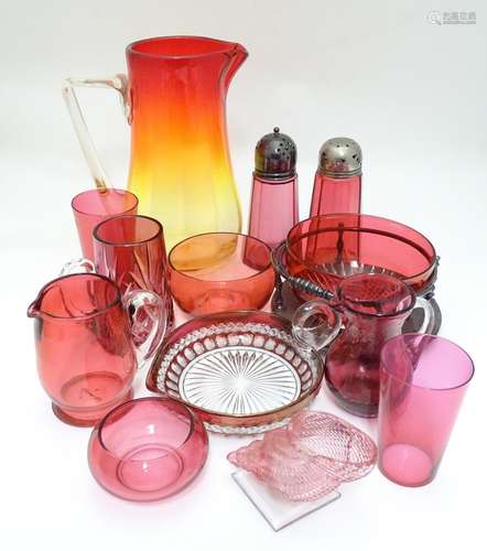 An assortment of cranberry glass items, to include sugar sifters, beakers, bowls, a salt formed as