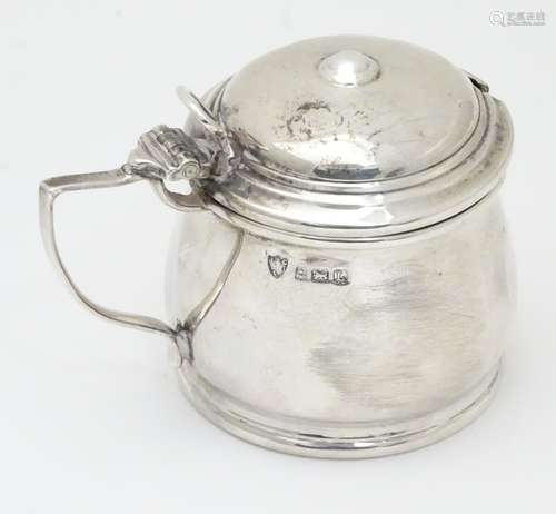 A silver mustard pot with blue glass liner, hallmarked Birmingham 1935 maker J B Chatterley & Sons