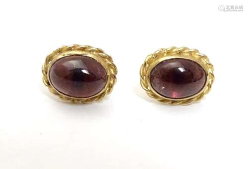 A pair of 9ct gold stud earrings set with garnet cabochon Approx 1/4