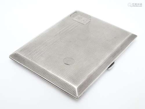 An Art Deco silver cigarette case with engine turned decoration and gilded interior. Hallmarked