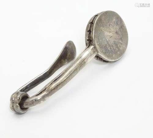 A silver napkin clip 1 3/4