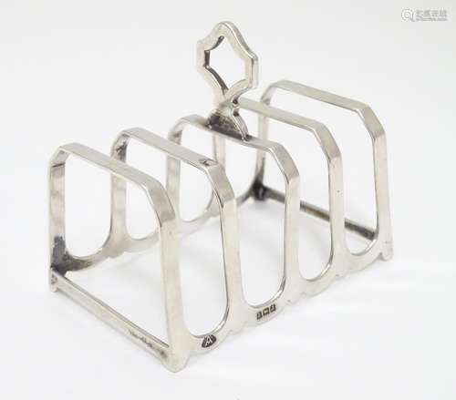 A silver four slice toast rack, hallmarked Birmingham 1933, maker Adie Bros Ltd. 3