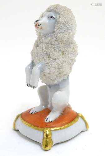 A Continental model of a seated begging poodle dog. Marked under with crown and S. Approx. 3