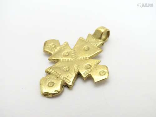 A yellow metal pendant of cross form with punch decoration. Possibly 18thC 1 1/4