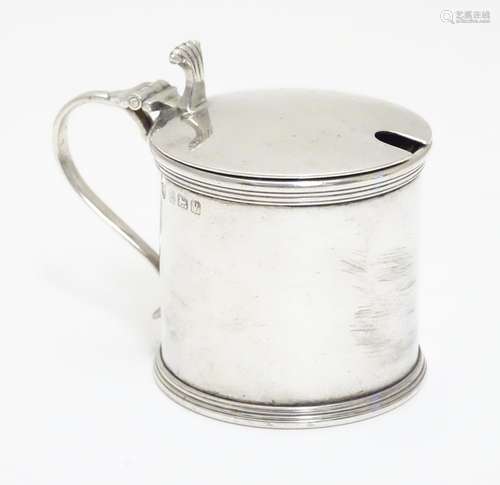 A silver mustard pot with blue glass liner, hallmarked Birmingham 1920 maker J B Chatterley & Sons