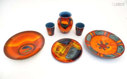 Six items of 20thC Poole Pottery, to include vase, plates etc. with a stylised orange and blue