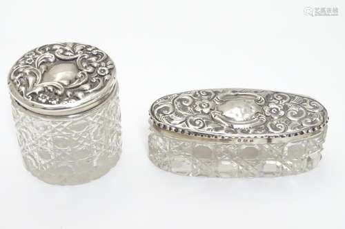 A glass dressing table jar with silver top hallmarked London 1908 maker H J Cooper & Co Ltd together