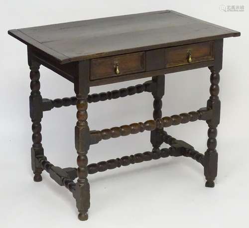 A mid / late 17thC oak side table with a proud top above a single long drawer with moulded