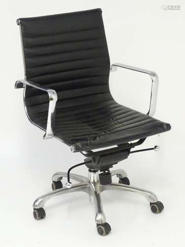 A late 20thC / early 21stC swivel office chair in the style of Ray and Charles Eames. with leather