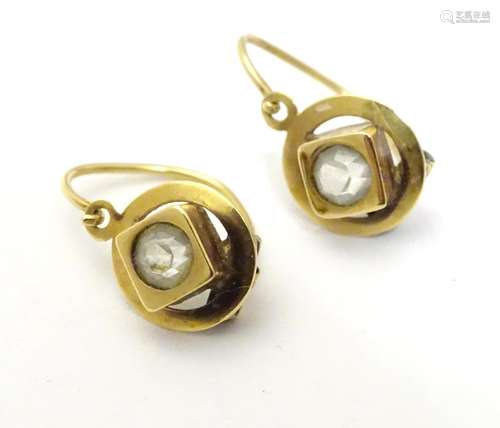 A pair of 19th gold earrings set with central paste stones. (unmarked tests as 18ct gold) approx 1/