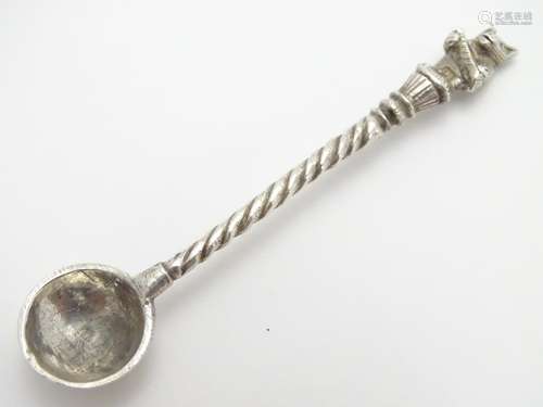 A white metal salt spoon, the handle surmounted by a bear 2 3/4