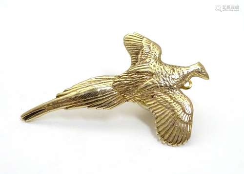 A 9ct brooch / pin formed as a pheasant in flight. 1 1/2