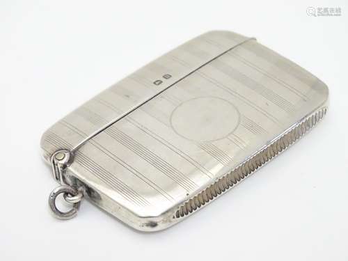 A silver vesta case with engine turned banded decoration. Hallmarked Birmingham 1919 maker Charles