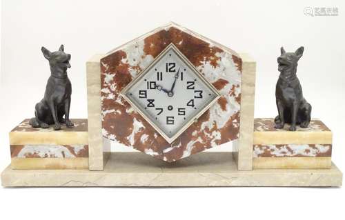 An Art Deco red and grey marble mantel clock, the supporting sections surmounted by seated