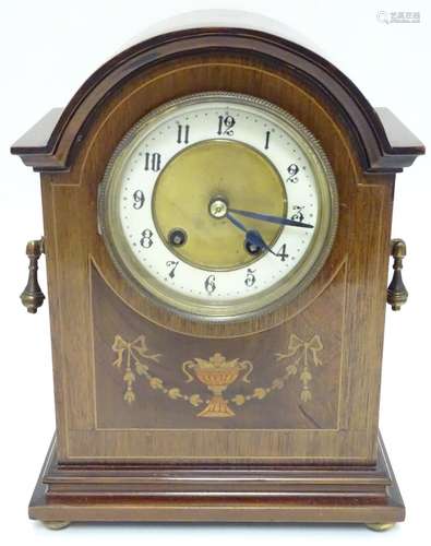 An Edwardian mahogany cased mantel clock, with Sheraton style inlays and enamelled dial. 10 3/4