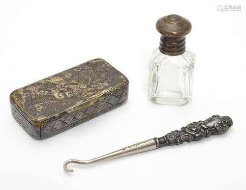 Three items comprising a small button hook with white metal handle a small glass bottle and a