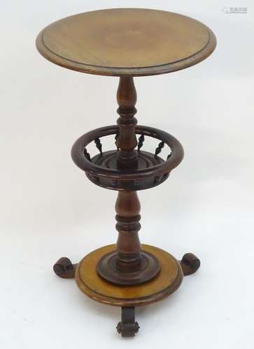 A 19thC mahogany tripod table with a circular top above a rounded under tier with turned finial