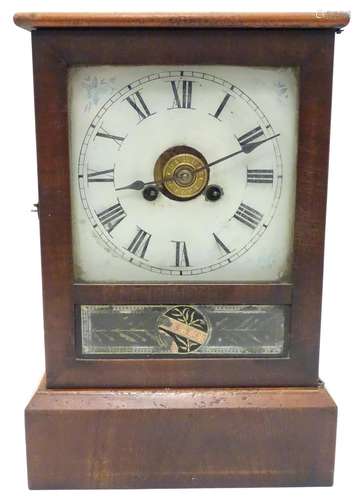 A late 19thC 'Kipper box' clock by Jerome & Co, the mahogany case with glazed door over an enamelled