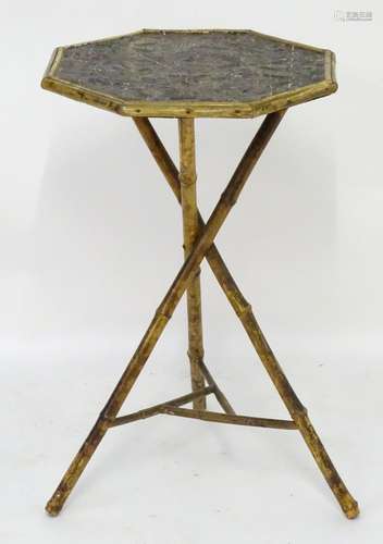 A late 19thC Meiji period occasional table with an octagonal top having a embossed gilt surface