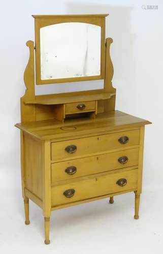 A late 19thC / early 20thC walnut dressing table, having a moulded cornice above an arched