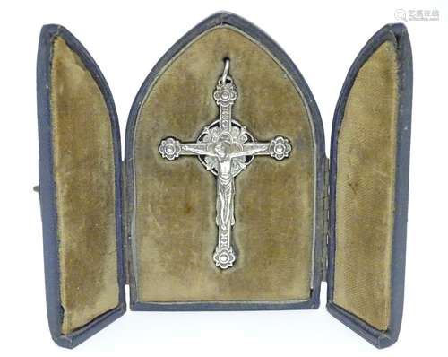 A late 19thC / early 20thC white metal bifacial cross / crucifix with pendant hanger within a fitted