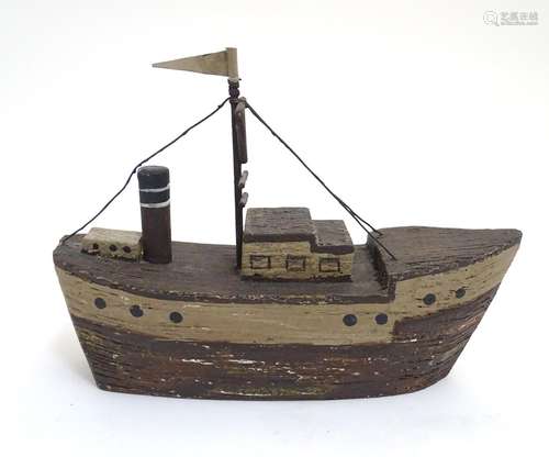 A 20thC naive folk art wooden model of a steamship / boat with polychrome decoration. Approx. 6 1/4